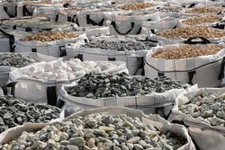 A lot of one cubic meter bags filled with variations of garden decorative crushed stones in the Hardware Store.