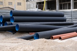 Huge water and sewer a new pipe tube at a construction site, stacked pvc plastic pipe. Engineering system construction in Israel