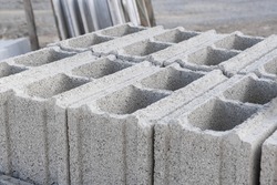 Pallet of Concrete Cinder Blocks, Grey Uniformed brick Shapes building material. New for use  on construction site in Israel. 