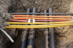 connecting underground cable infrastructure improvement installation. Construction site with A lot of communication Cables protected in tubes. high speed Internet Network cables are buried 