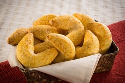 Basket with boomerang shaped cheese bread, on a red fabric