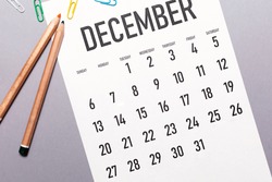 December 2020 simple calendar with office supplies and copy space