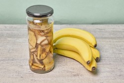 A jar filled with banana peel cuts and water. Banana peel for plant fertilization. Eco friendly natural way of fruit waste compost. Banana peel compost