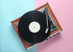 Vinyl player on a blue pink pastel background. Top View