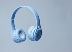 3D surround photo blue wireless headphones on gray background.