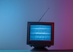 Mini Retro tv antenna receiver. Old fashioned TV set. Pink blue gradient neon light. Television noise, no signal. 80s retro wave