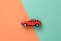 Model toy car on a blue-pink background. Top view. Flat lay