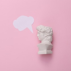 Bust of David with dialog cloud on pink background. Minimal still life