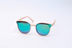 Stylish sunglasses with turquoise glass reflection isolated on white background
