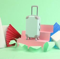 Travel luggage on green torn background with geometric shapes. Minmalism. Concept art
