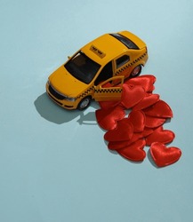 Taxi car with hearts on blue background. Love concept, valentine's day, february 14th celebration, creative layout