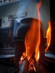 A pot was kept under the fire. Fire makes an incredible design