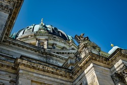 Impressive religious architecture: view from below to the staggered facade and the cupola of the Berlin Cathedral