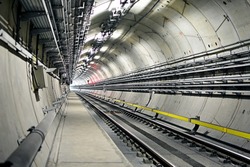 Metro tunnel (subway or underground) with precast concrete linings (segments or rings) with lights of an approaching train