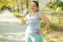 Fat woman and sports. Does exercise for weight loss in the fresh air. High quality photo.