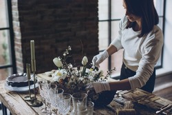 Table setting. A woman decorates the table for the holiday. High quality photo