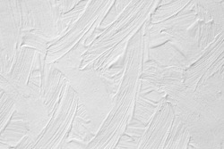 The texture of the paint is white. Wall background with plaster and stains. A screensaver or a postcard for a holiday.