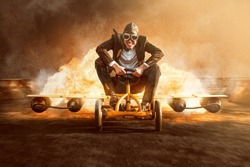 Businessman on a pedal car with a rocket engine