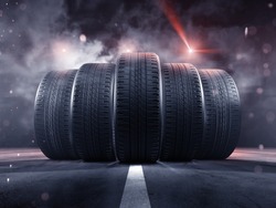 Five tires rolling on a street