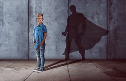 Child with superhero shadow
