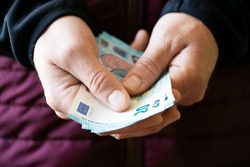 Euro money twenty bills closeup in white man hands