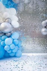 Photo zone with balloons, confetti and sparkling mirror background. Birthday decor. Festive decoration. Balloons. Childrens party background. Festive photo zone in blue.