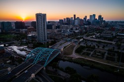 Sun rises over horizon in the mountain town of Denver , Morning Sunrise in the Mile High City of Denver , Colorado , USA golden hour Traffic and gorgeous sunshine aerial drone view above bridges