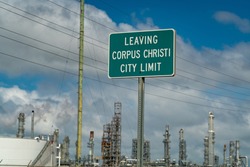 Leaving Corpus Christi City Limits Sign surrounded by Oil Refineries 