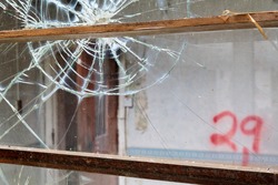 Broken windows inside Whittingham Mental Asylum, the largest abandoned hospital in Europe
