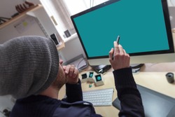 Creative man pointing at desktop screen with a digital  graphics pen. 