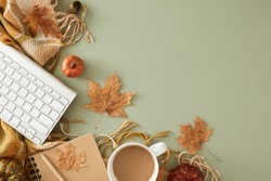 Creating a cozy home office for autumn. Top view shot of pen, copybook, keyboard, warm plaid, acorns, pumpkins, dry leaves on pastel olive background with blank space for advert or text