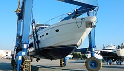 motor yacht is raised with a special crane for repair