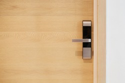Wood door with digital door lock systems best security protection for apartment. Electronic door handle installed on wood door. Selective focus