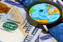 Watch with global map on cash money. World map clock. Worldwide business concept. Cash banknotes background. Global business. Worldwide business travel. Emerging market profit. Economy globalisation