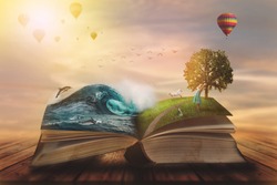 
Concept of an open magic book; open pages with water and land and small child. Fantasy, nature or learning concept, with copy space