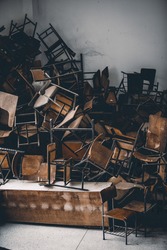 vintage tone image of old chairs on a pile under natural lights