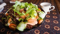 Salted salmon salad with fresh green lettuce, cucumbers, tomato, bell pepper and red onion. fresh raw salmon fish cooking food seafood salmon fish healthy food, salmon fillet with vegetable