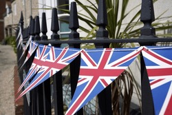 View of British Union Flag bunting on railings outside a house