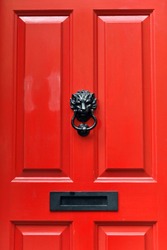 Close-up View of a Traditional Style Red Front Door of an Upscale English Town House