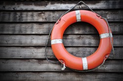 Life Buoy attached to a Wooden Paneled Wall with Plenty of Copy Space