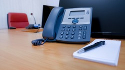IP telephone on working table in meeting room.