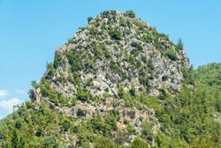 A massive rocky hill with the ruins of Alara Castle in Alanya, Turkey. The castle dates from the 13th century.