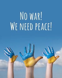 Child's hands painted in the colors of the national flag of Ukraine on blue sky background. Text - No war We nees peace