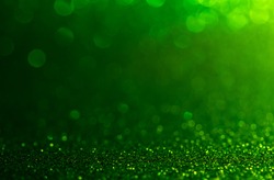 green Sparkling Lights Festive background with texture. Abstract Christmas twinkled bright bokeh defocused