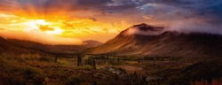 Beautiful Panoramic View of Colourful Fall Forest and Mountains in Tombstone. Sunset or Sunrise Sky Composite. Tombstone Territorial Park, Yukon, Canada. Nature Background Panorama