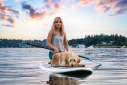 Girl with a dog on a paddle board during a vibrant summer sunset. Taken in Deep Cove, North Vancouver, BC, Canada. Colorful Art Render