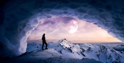 Magical Fantasy Adventure Composite of Man Hiking in an Ice Cave with Winter Mountain Landscape. Colorful Sunset Sky Art Render. Background taken from British Columbia, Canada.