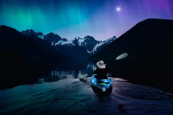 Adventure Person Kayaking in a Peaceful Lake at Night. Colorful Sky with Starts and Aurora Art Render. Canadian Landscape from British Columbia, Canada.
