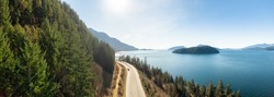 Aerial Panoramic View of Sea to Sky Highway on Pacific Ocean West Coast. Sunny Winter Day. Located in Howe Sound between Vancouver and Squamish, British Columbia, Canada.