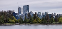 Seawall around Stanley Park with Highrise Buildings in background. Modern City Skyline. Downtown Vancouver, British Columbia, Canada.